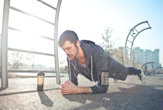 A man doing a plank, showing one of the workouts to build core strength.